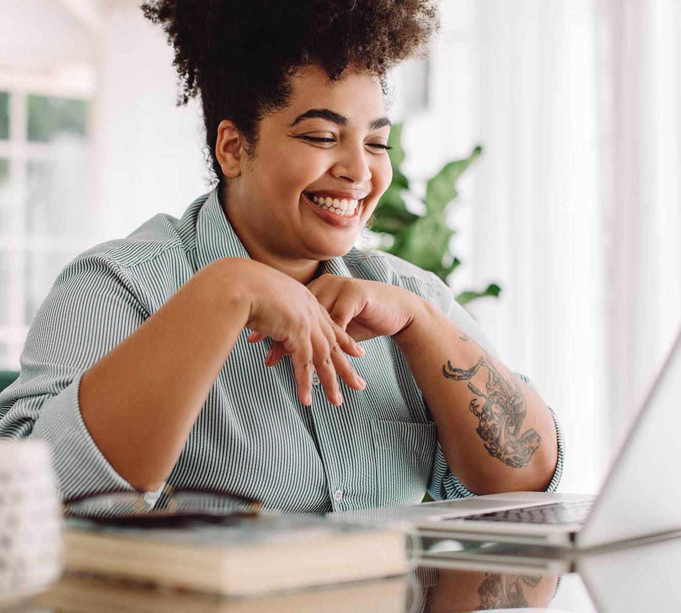 Therapist smiling at laptop screen because they know how to name their therapy niche